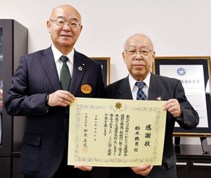 北海道知事感謝状の伝達を受けた鈴木さん(右) == 株式会社伝書鳩|経済の伝書鳩|北見・網走・オホーツクのフリーペーパー ==
